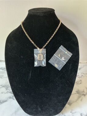 Ava Delora Gold Tone Chain Necklace with Rectangular Locket and Charms
